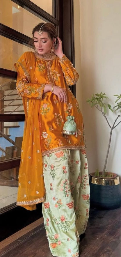 3-piece embroidered suit in mustard yellow. With beautiful floral embroidery on shirt and trouser paired with a fancy 4-side embroidered chiffon dupatta