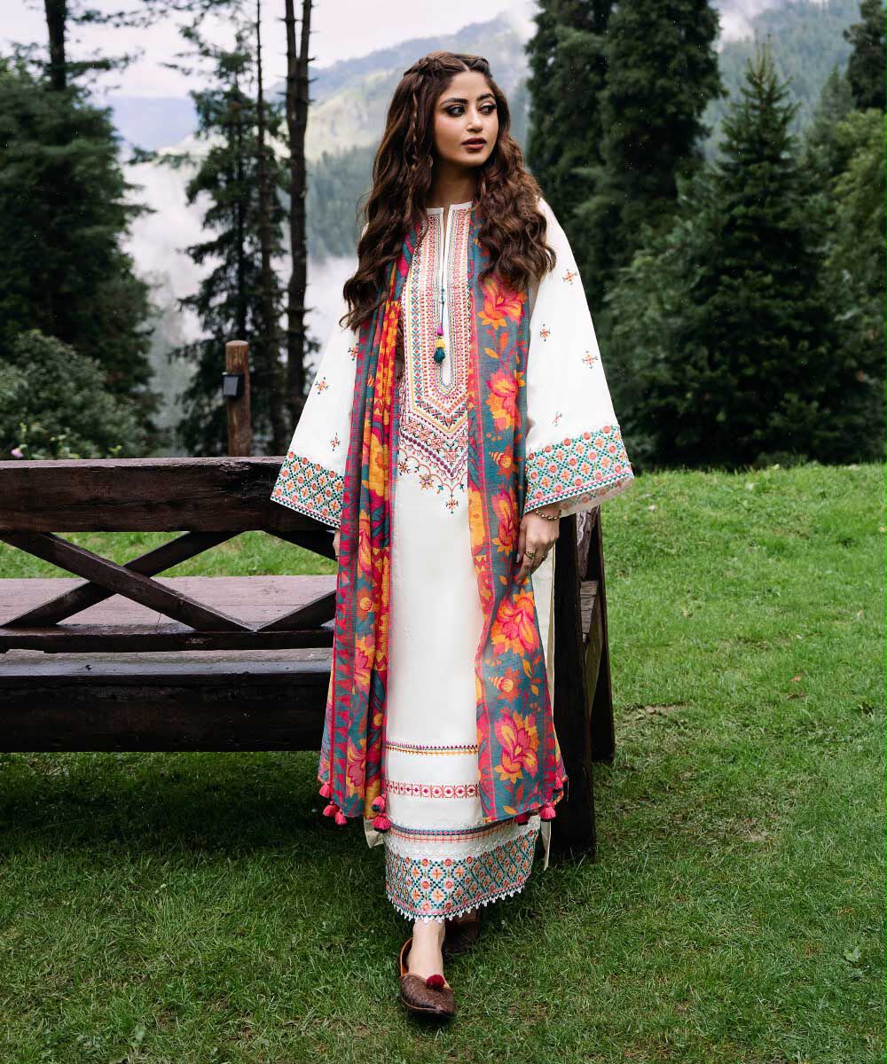 Off-white dhanak fabric pieces showing heavy front embroidery, sleeves embroidery, plain trouser, and magenta-yellow digital printed wool shawl