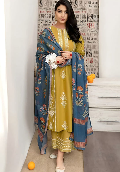 Woman wearing a mustard embroidered Dhanak suit with a blue floral shawl