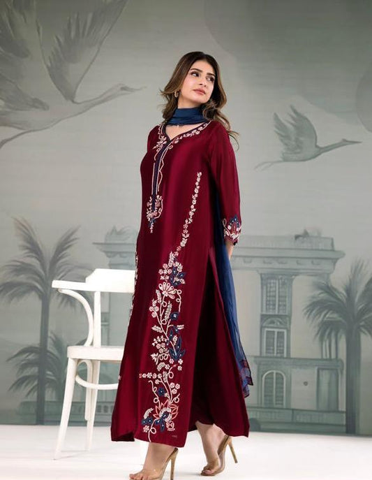 Model wearing maroon IZNIK embroidered Dhanak Marina shirt with blue printed shawl, 3-piece winter suit